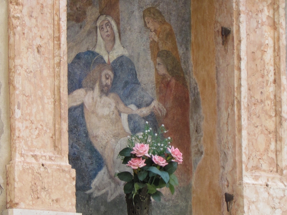 Religious artwork with a flower offering.