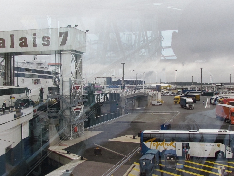 Port terminal with buses and ferry dock.