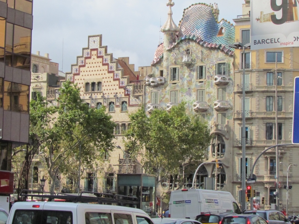 View of colorful buildings in a city street with artistic facades.