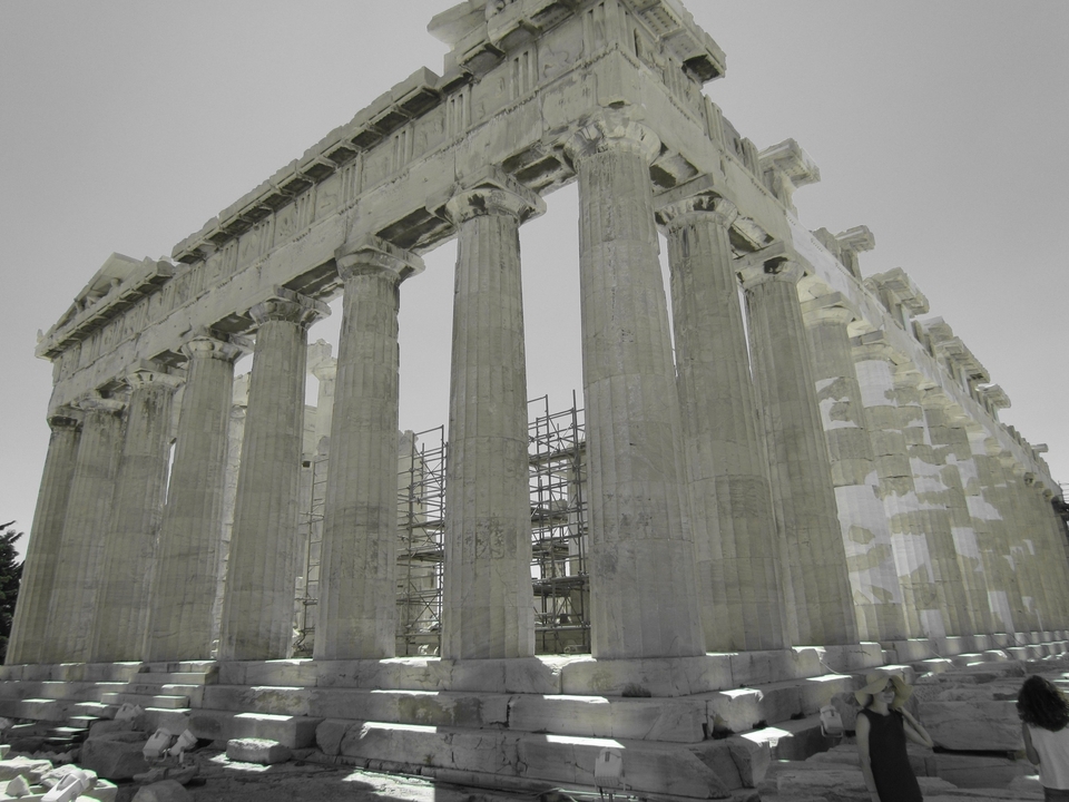 Large ancient temple with columns under a clear sky.