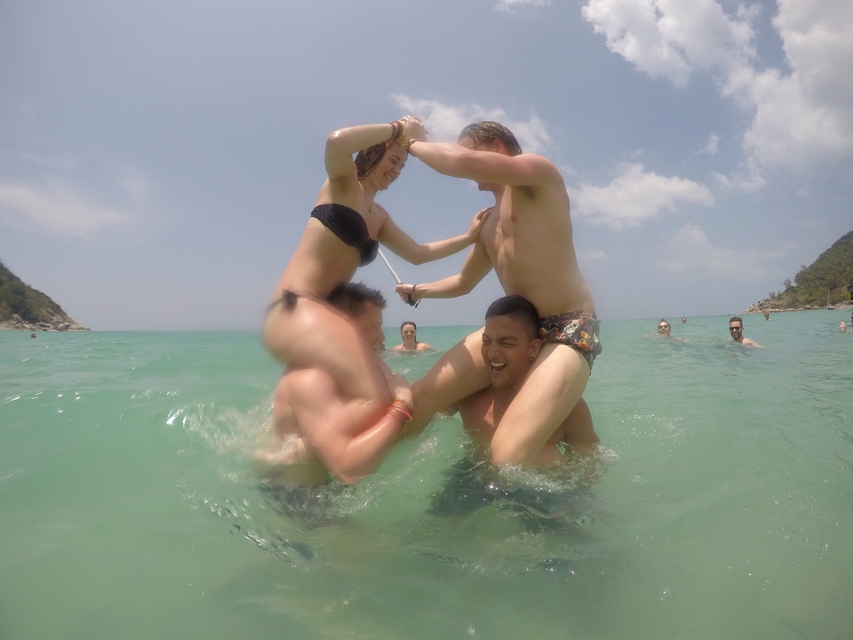 Two people playing in the water, having fun at the beach.