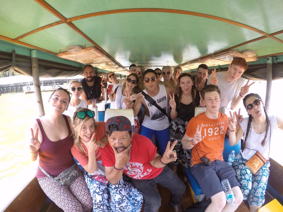 Group of people taking a selfie inside a boat.
