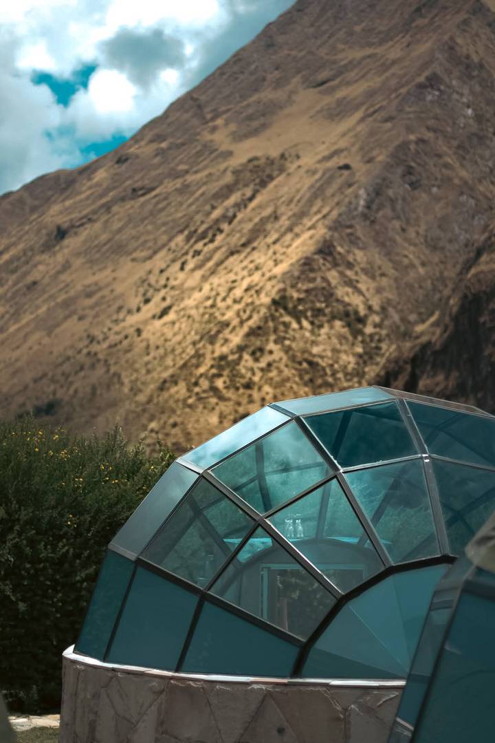 A geodesic dome with a mountainous backdrop.
