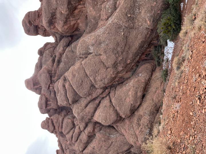 Rocky cliff formations with a clear sky in the background.