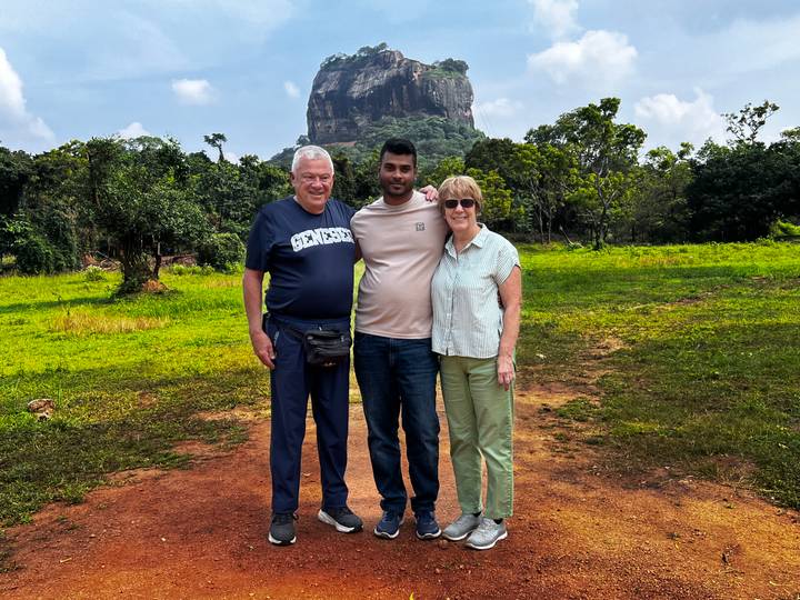 Group of people posing in front of Sigiriya Rock Fortress.