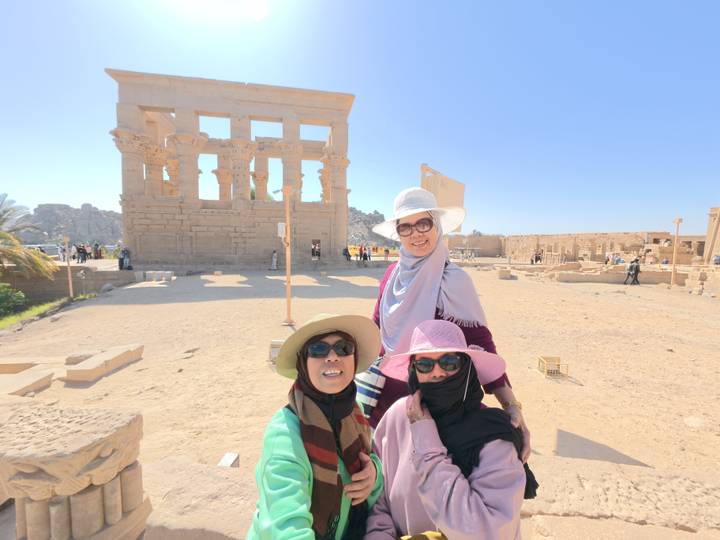 Group of women posing in front of ancient ruins.