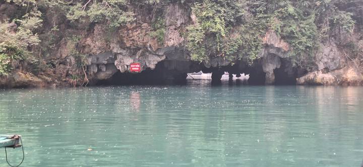 Grotingang boven een waterlichaam met boten op de achtergrond.