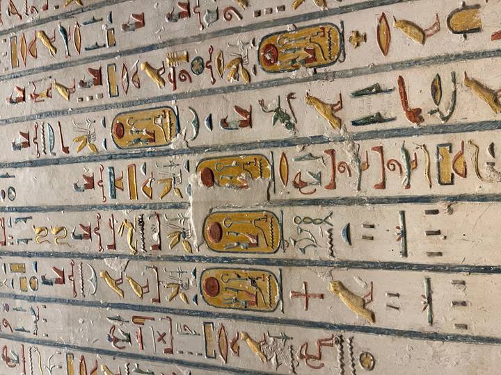 Detailed hieroglyphs carved on a wall.