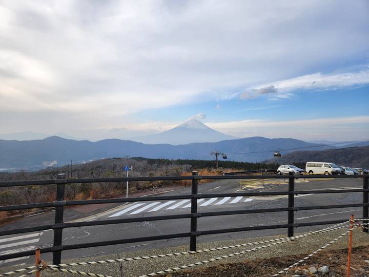 Roadside view with distant Mount Fuji in the background.