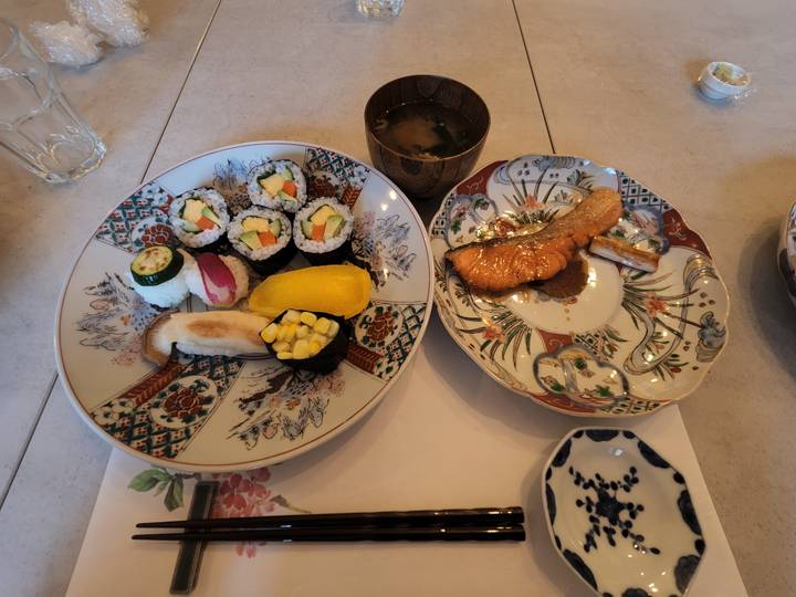 Close-up of artistic sushi and sashimi plates.
