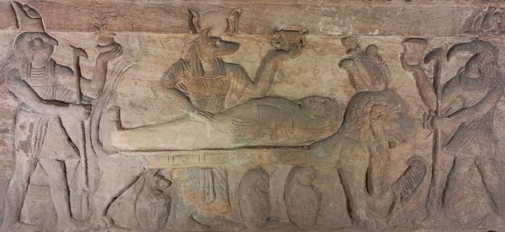 Ancient Egyptian wall carvings in a tomb or temple.