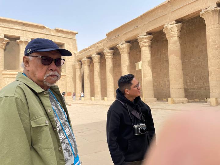Older man and younger man at an ancient temple.