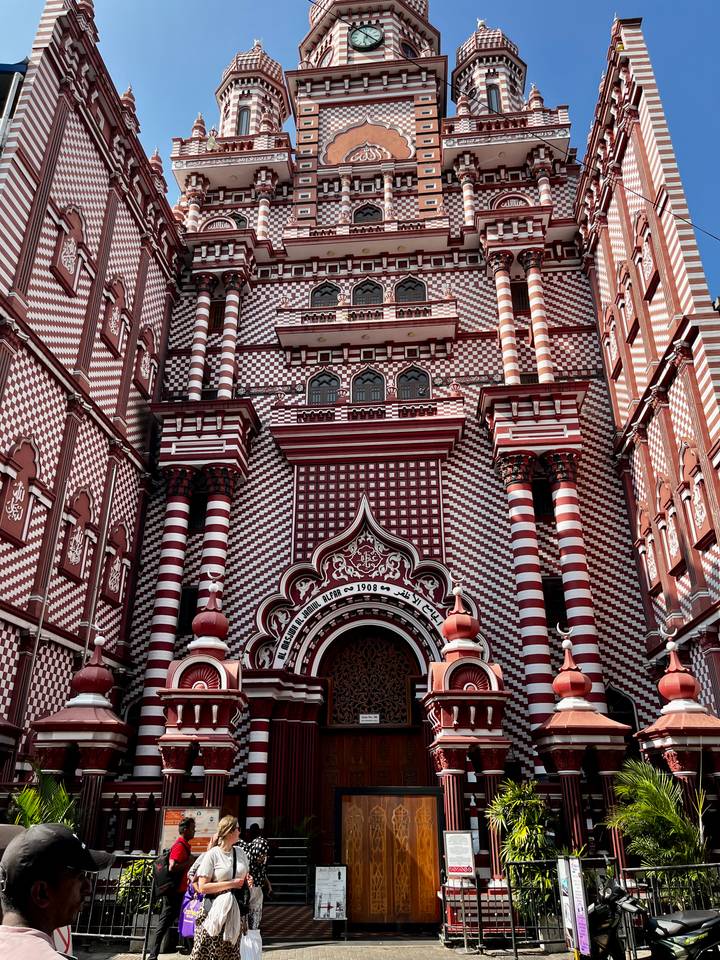 Resort pool with palm trees silhouetted against the evening sky.