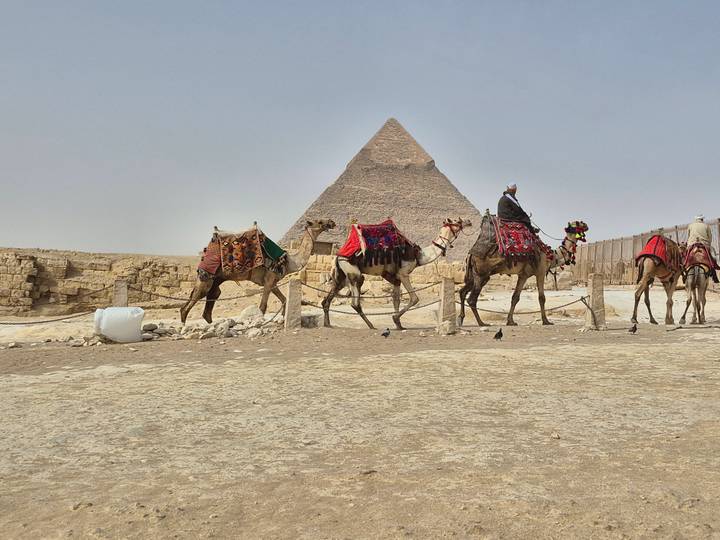 Camel riders in front of the Great Pyramid of Giza.