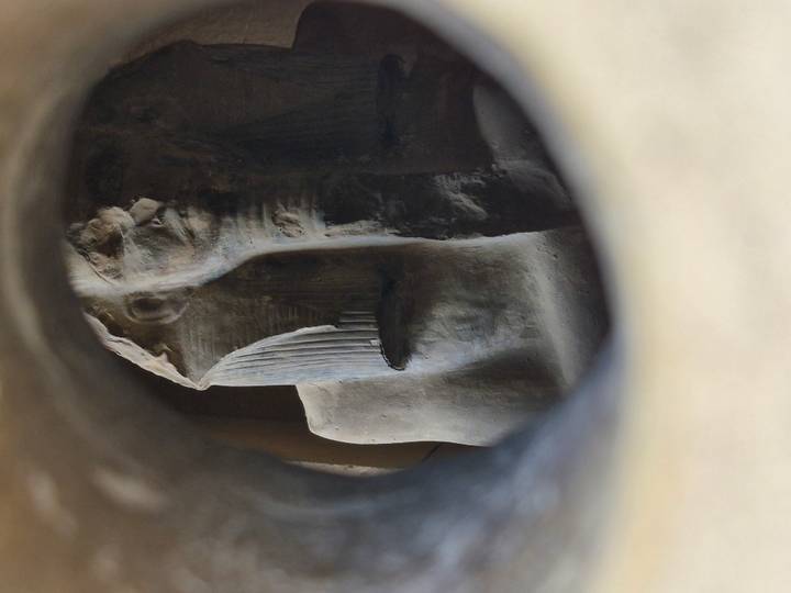 Sphinx statue framed by a circular opening.