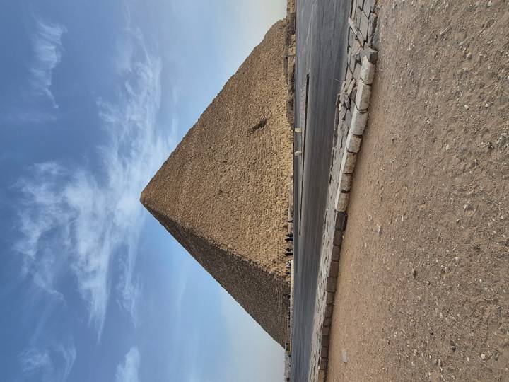 Pyramid with clear blue sky and some clouds.