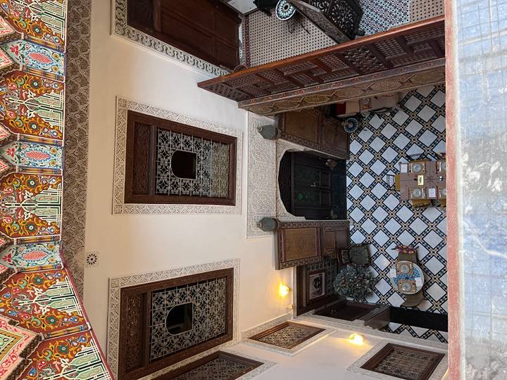 View from above in a traditional Moroccan courtyard focusing on intricate mounted decorations and designs.