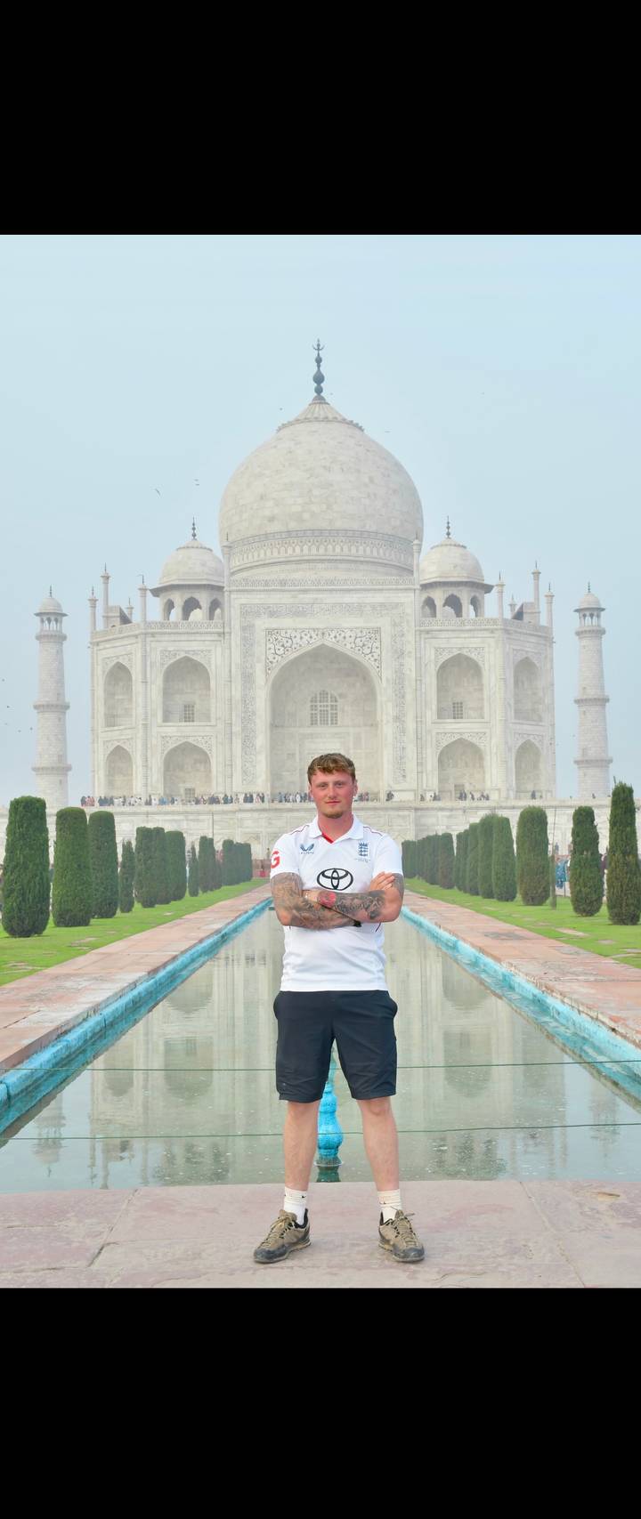 Person standing in front of the Taj Mahal.