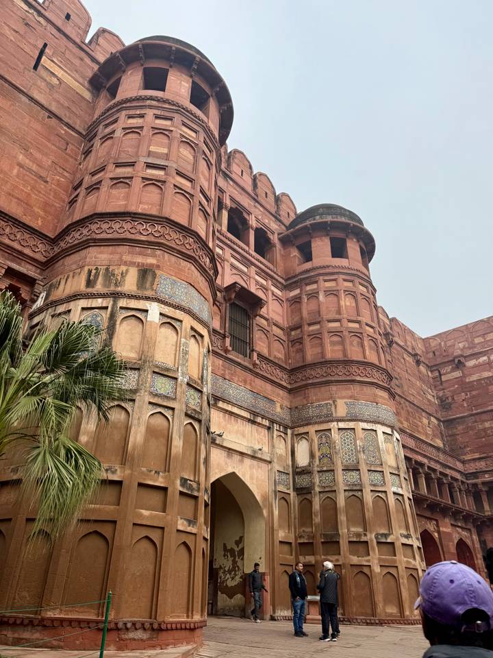 Detailed red-sandstone bastions and towers of Agra Fort with tiled inlay