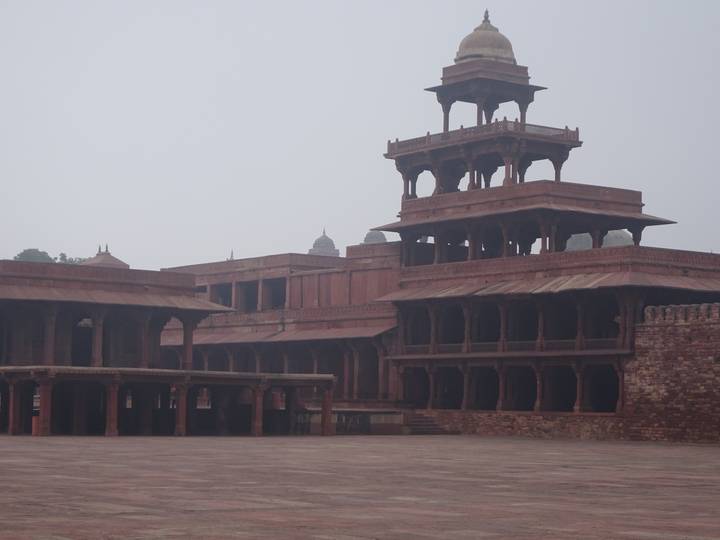 Hazy morning view of red sandstone palace structures at Fatehpur Sikri.