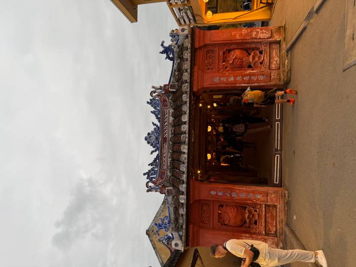 Japanese Covered Bridge in Hoi An glowing at dusk as visitors walk through.