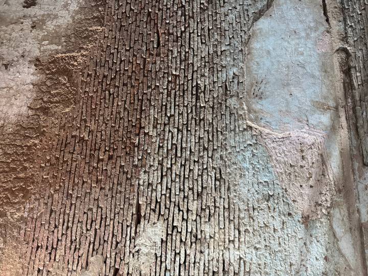 Close-up of an aged brick wall with varying colors and textures.