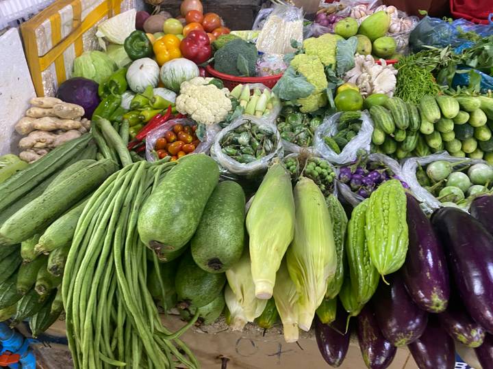 Colorful assortment of fresh vegetables neatly arranged at a local market stall