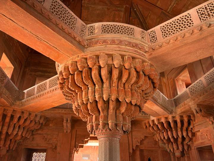 Intricately carved central pillar and radiating brackets of Fatehpur Sikri's Diwan-i-Khas