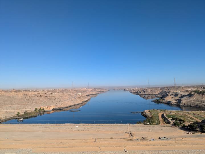 Expansive view over the deep-blue waters of Lake Nasser flanked by desert hills under a clear sky.