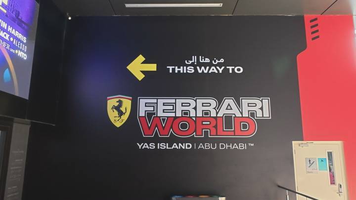 Indoor directional sign pointing the way to Ferrari World on Yas Island, Abu Dhabi.