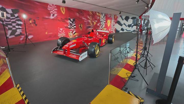 Exhibition of a red Formula-1 Ferrari race car inside Ferrari World theme park.