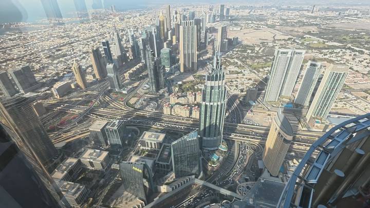 Sweeping aerial view of downtown Dubai’s skyscrapers and highways taken from a high observation deck.