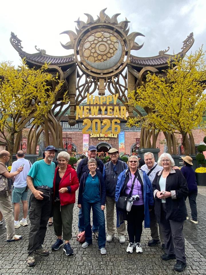 Tour group posing under ‘Happy New Year 2026’ archway at SunWorld Ba Na Hills