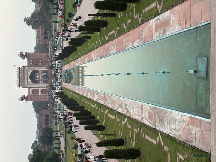 Long axial pool leads to the grand entrance gate opposite the Taj Mahal complex.