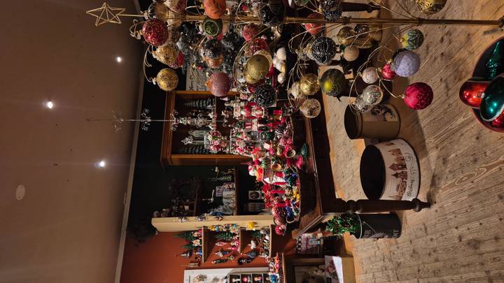 Cozy indoor Christmas shop filled with colorful ornaments and festive displays