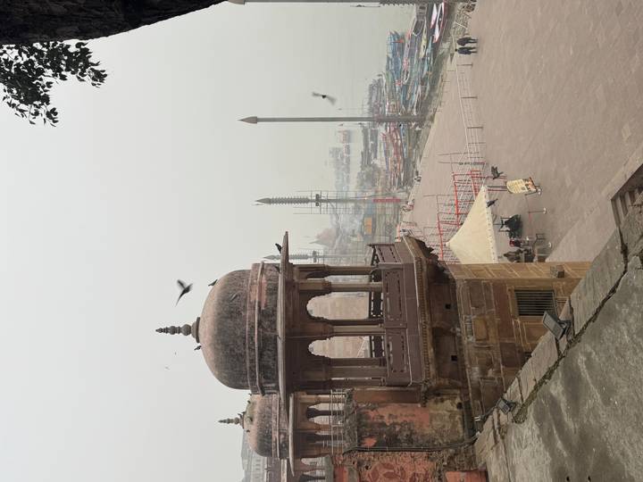 Mughal-style riverside pavilion overlooking misty ghats and boats on the Ganges.