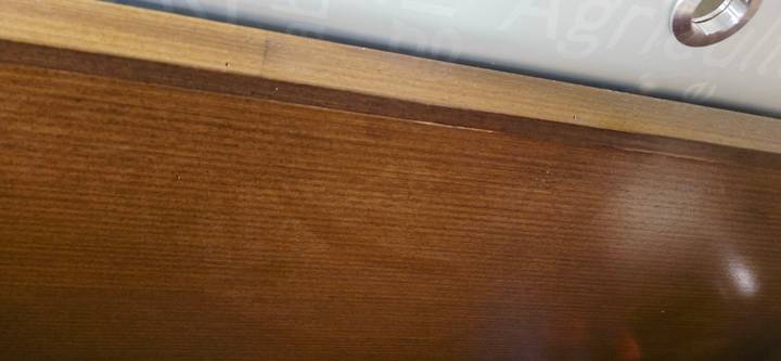 Close-up of a plain wooden door surface with little contextual information.