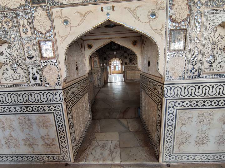 Intricately inlaid marble corridor inside an Indian palace, rich in floral motifs