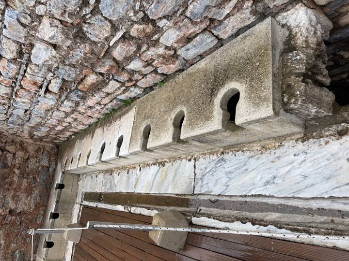 Ancient stone and marble communal latrine seats in Ephesus.