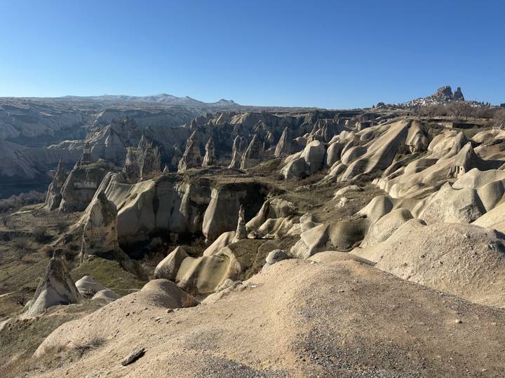Expansive view over Cappadocia's rugged valleys and fairy chimney formations.