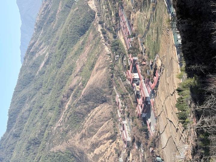 Aerial view of Paro Dzong complex nestled in a forested Himalayan valley.