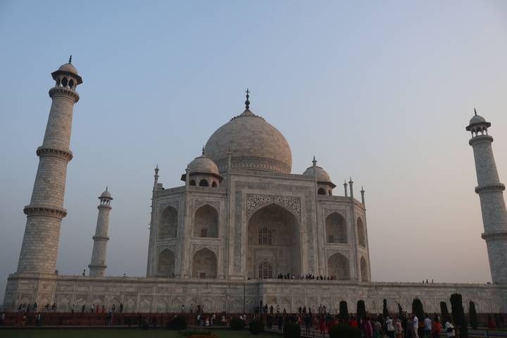 Side angle of the Taj Mahal at dusk with soft pastel sky.