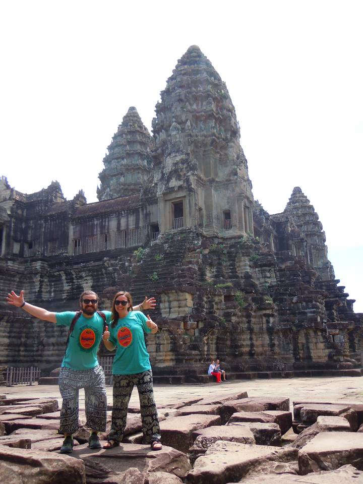 Two people posing in front of ancient ruins.