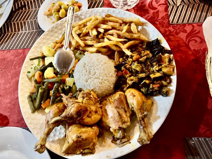Repeat: Moroccan mixed platter featuring rice, vegetables and chicken.