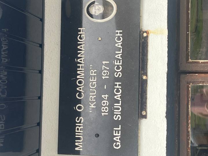 Close-up of an engraved memorial plaque with Gaelic and English text referencing ‘Kruger’.