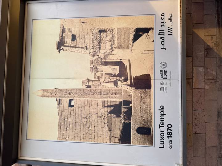 Historical display panel showing vintage photo of Luxor Temple and bilingual captions.