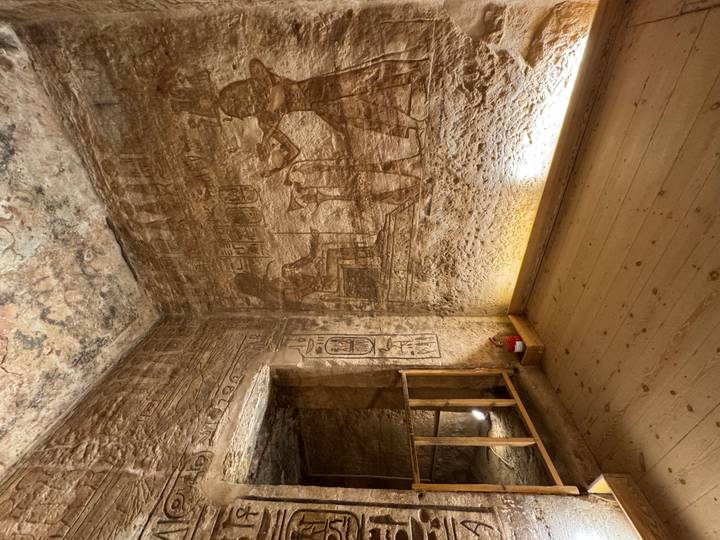 Interior of an ancient tomb chamber with detailed wall hieroglyphs and subtle lighting.