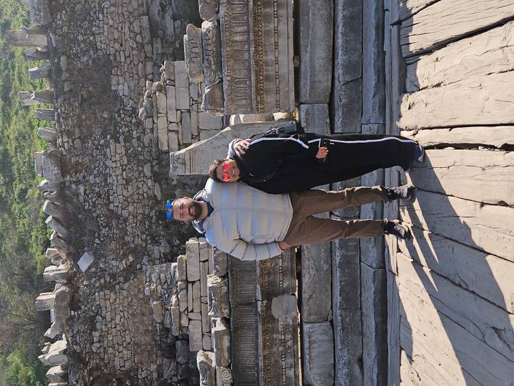 Travelling pair stand amid ancient marble ruins at Ephesus.