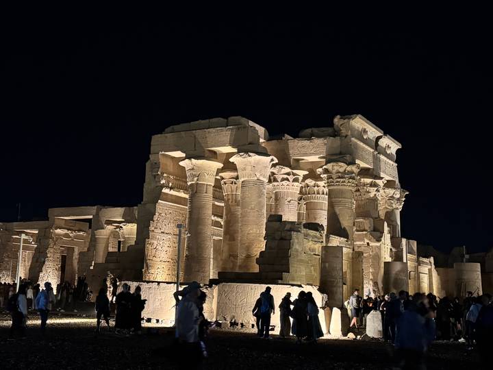 Nighttime crowds admire the dramatically lit columns of Kom Ombo Temple.
