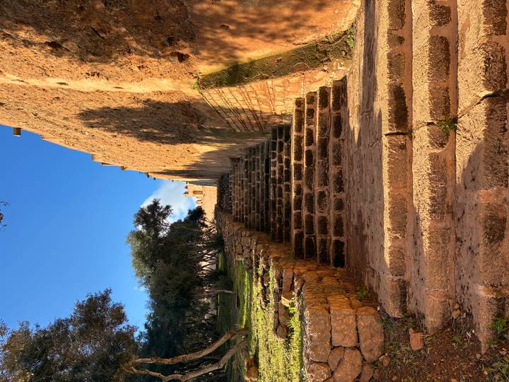 Stone staircase leading up old fortress walls basking in late afternoon sun.